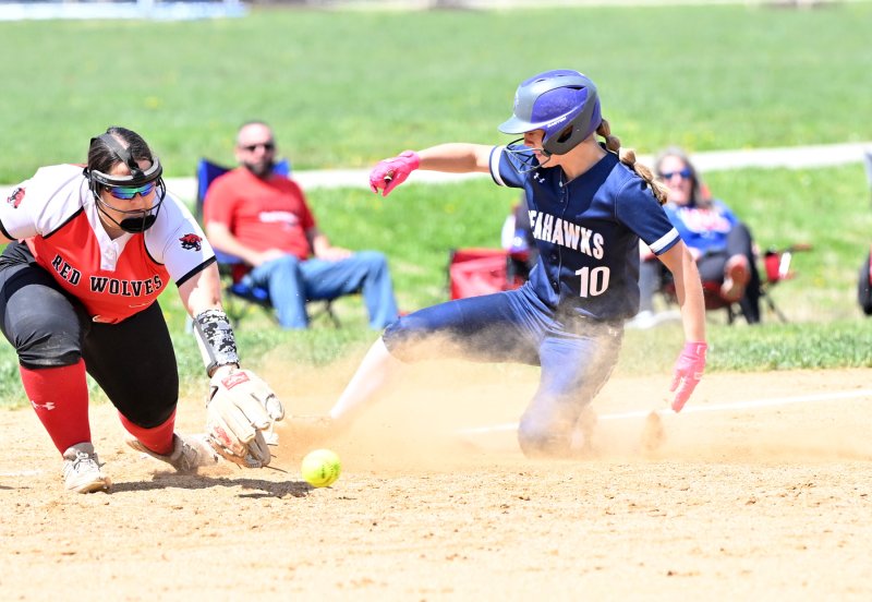 Sussex Academy freshman Danica Bergh slides safely into third on her triple in the bottom of the first inning.