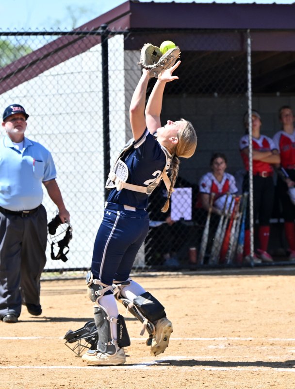 Senior catcher Delainie Monitzer fights off a bright sun and makes a play for an out.