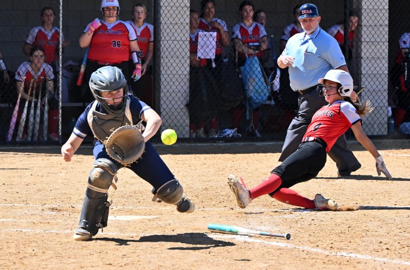 Conrad senior pitcher Olivia George scores for the Red Wolves.
