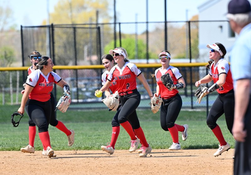 Conrad centerfielder Julia Abbott celebrates the final out with her teammates.