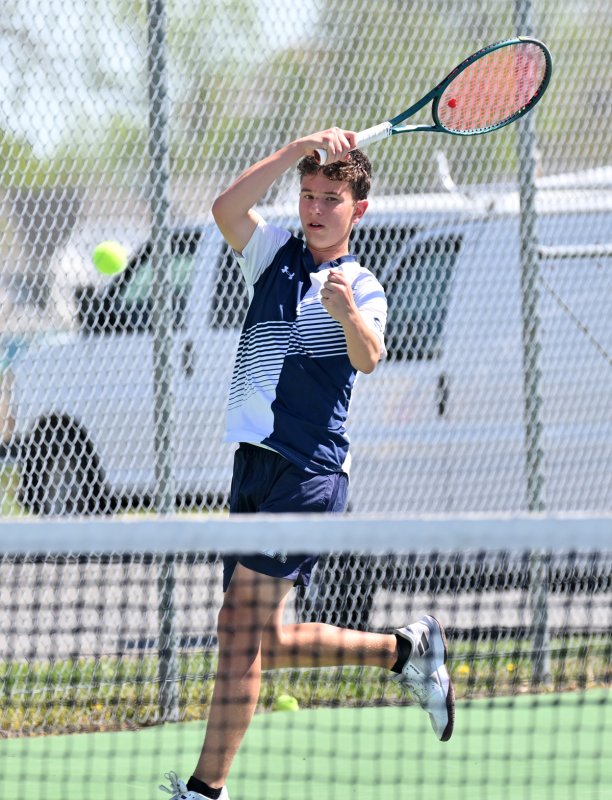 Sussex Academy’s Jack Feinstein slams a forehand at first singles.