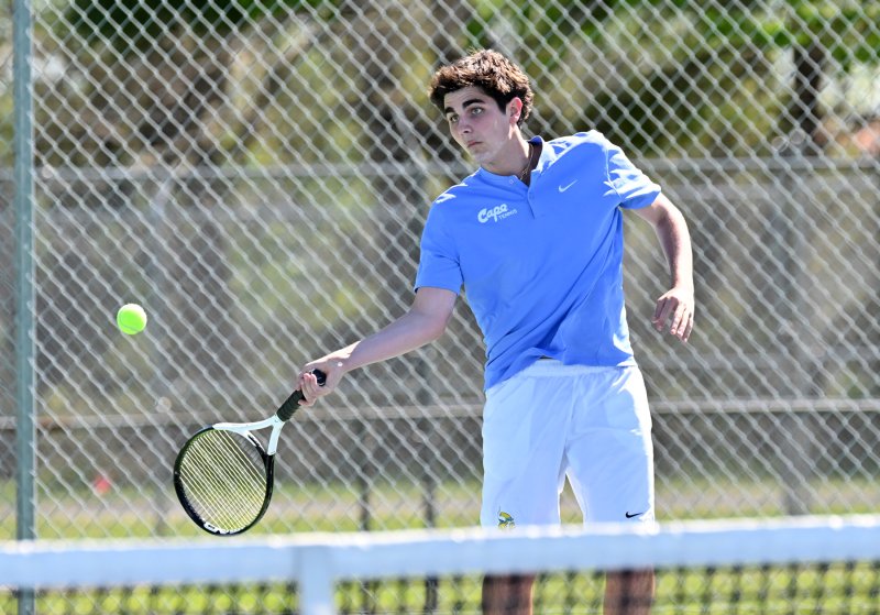 Cape’s Michael Gordon hits a forehand drive at first doubles.