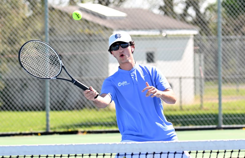 Cape’s Caidan Juliano hits a forehand volley at third singles.