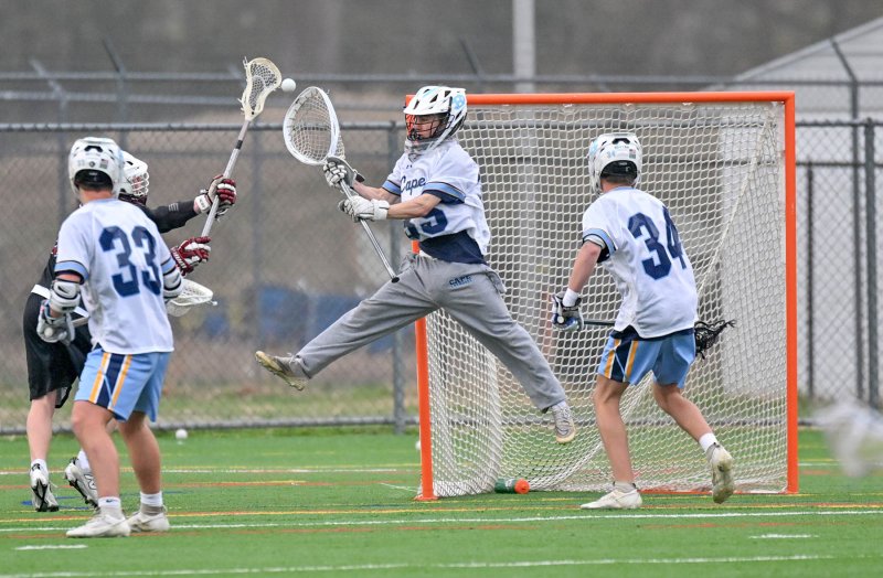 Cape goalie Mason Trench gets major air and makes one of his 10 saves in the contest. DAN COOK PHOTOS