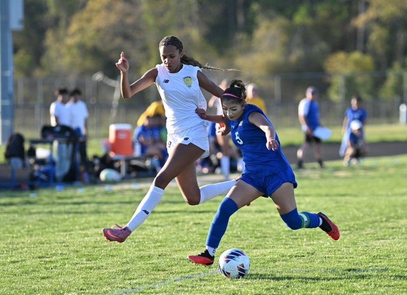 Cape senior Ava Brown gets major air to battle for the ball from Central’s Belinda Roblero Perez.