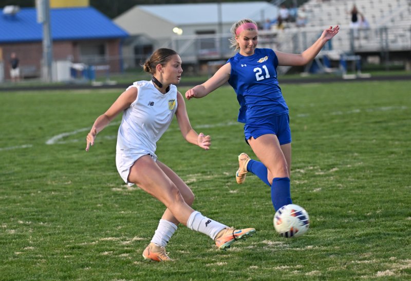 Kailey McMahon blasts a pass for the Vikings while Elizabeth Hicks defends.
