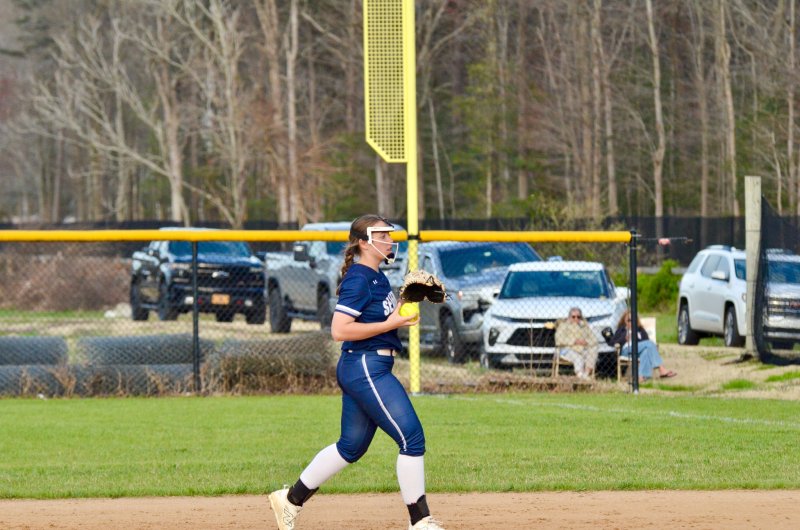 Seahawks junior Grayce Glover begins to toss the ball in after catching a fly ball.