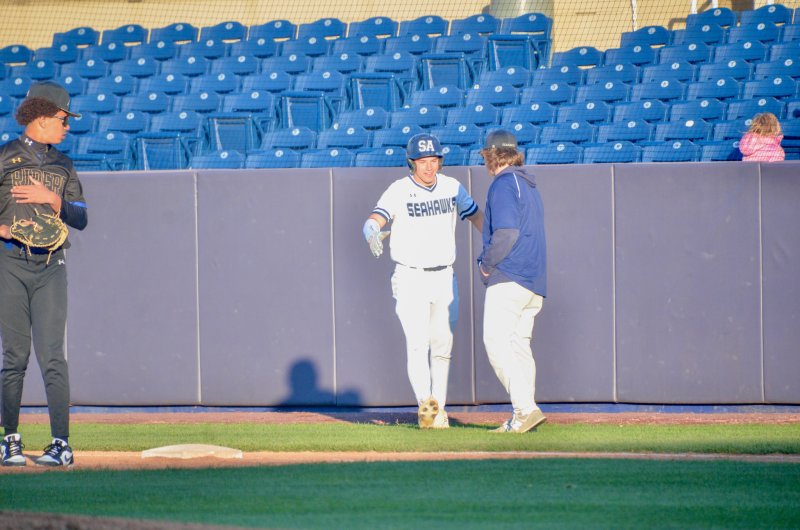 Sussex Academy sophomore Mason Glover gets some love after legging out an infield hit.