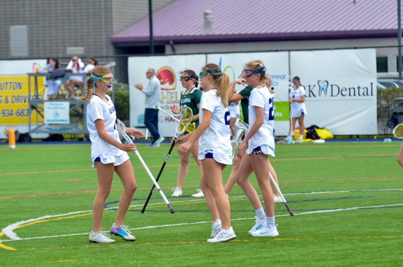 Brooklyn Montgomery, left, and June Hale celebrate Liz Layton’s goal in the second quarter of the girls 17-3 loss to Tower Hill April 11.