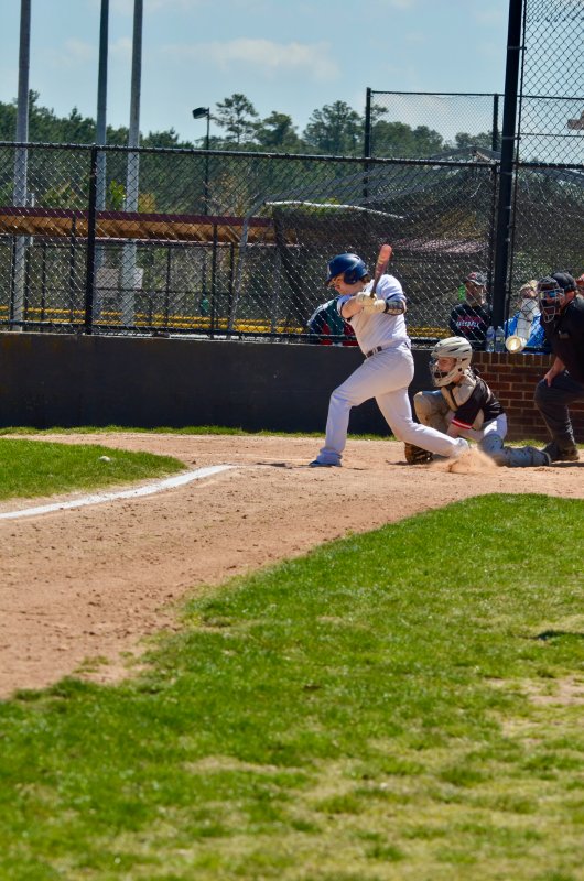 Sussex Academy junior Derek Sachs sends a rocket down the third base line to drive in a run.