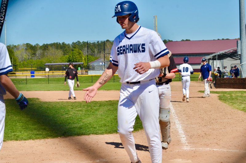 Sussex Academy sophomore Ben Tollett is congratulated after scoring.