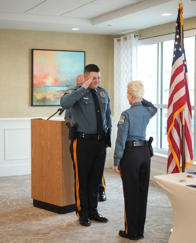 Cpl. James Rieley, left, salutes Chief Constance Speake after his promotion.