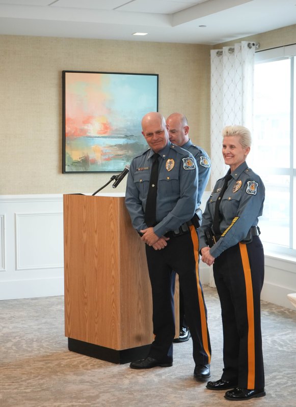 Staff Cpl. Matthew Planer, middle, is promoted from the rank of corporal. Chief Constance Speake is to the right. Lt. Cliff Dempsey is behind Planer.