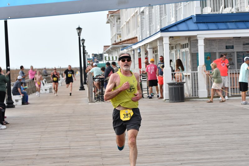 John Costello, 65, takes first place in the male grand masters category with a time of 21:16.