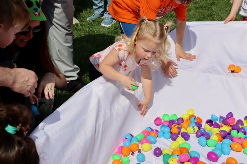 Grace Dean, 2, reaches into the boat for Easter eggs.