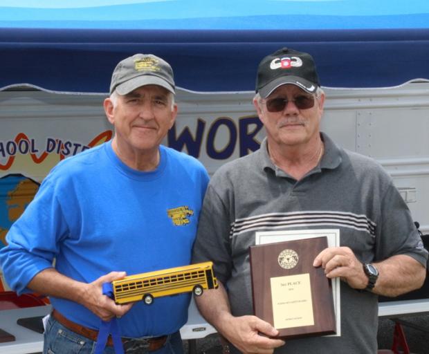 Delaware State Director of Pupil Transportation Ron Love, left, congratulates Cape Henlopen school bus driver Ed Brouillette for his success in the school bus safety competition. SUBMITTED PHOTO