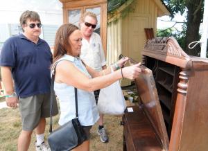 Janet Messina of Lewes and her friend Tim Latham admire an antique desk from Mother Fletcher Antiques as proprietor Ed Shockley, right, looks on. The Lewes Historical Society Antiques Show has the distinction of being the society's oldest continuing tradition. Comprised of many quality antique dealers from the Mid-Atlantic region, the show attracts over 2,500 visitors.