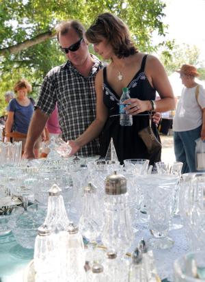 Paul and Amanda Breger of Wilmington shops for antique glassware from "Blue Heron Antiques" of Laytonsville, Md. Vintage hand-painted china, American brilliant cut glass and depression glass were just a sample of the glasswear displayed by many of the vendors.