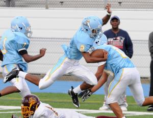 Cape running back Tyreik Burton hurdles over a Milford defensive back during the 30-8 Vikings victory. BY DAN COOK
