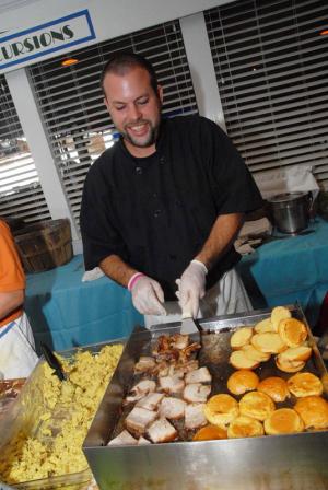 Working the grill for Cultured Pearl and Grub Grocery is executive chef Eric Johns. BY STEVEN BILLUPS