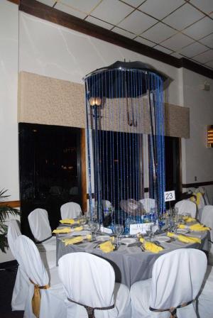 The table decorations for the annual event are created by local individuals and businesses and are judged for their creativity. The top five decorations are awarded Oscar Awards. Shown is the second place creation titled “Singing in the Rain” by Maureen Botti Eschbach of Aquamarine at 114. BY STEVEN BILLUPS