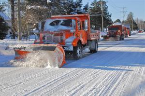 DelDOT trucks roll along Savannah Road in Lewes after one of two blizzards during the winter of 2010. BY RON MACARTHUR
