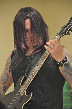 Dressed in black and silver, rocker Chris Kiker said he wanted to kick it up a notch during the talent contest. BY RON MACARTHUR