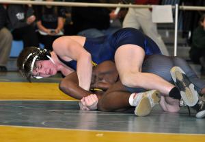 Cape senior Garrett Smith works against Milford's Alvonatae Drummond in a 138-pound match. BY NICK ROTH