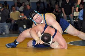 Thomas Ott sneaks a peek at the clock while wrestling Lake Forest's Marshall Hobbs in the state finals of the 220-pound weight class. BY NICK ROTH