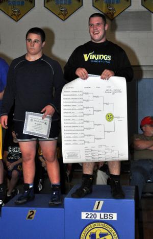 Thomas Ott stands atop the podium with runner up Marshall Hobbs of Lake Forest to his right. BY NICK ROTH