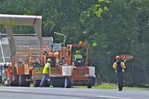 A crew finishes paving work along Route 404/9 near Georgetown. BY RON MACARTHUR