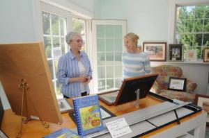 Watercolor painter Leslie Delmege McDonald, right, talks with Betty Hill about the unique locations she paints from around the world. BY STEVEN BILLUPS