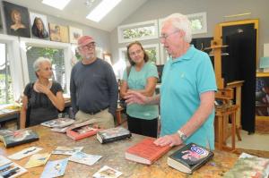 Painter Victor Letonoff, right, talks about the 50 years of sketchbooks he has assembled over the years with (l-r) Carol and Robby Morris and Kathy Stasiewicz. BY STEVEN BILLUPS