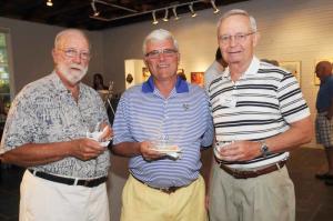 Socializing while enjoying the art are (l-r) Stan Cole, Dave Diebolt and art league volunteer Gerry Depken. BY STEVEN BILLUPS