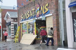 Jamie Fontello of Milton, left, and Frank Perticari of Lewes board up Sunsations on Rehoboth Avenue. BY NICK ROTH