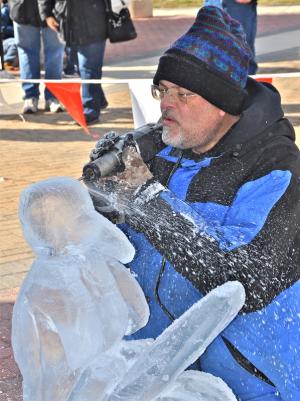 Dave Slaughter of Wilmington begins to carve his ice sculpture near the Bandstand in Rehoboth Beach. BY RON MACARTHUR