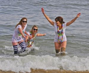It's fun to jump into near freezing water in February. At least that's what (l-r) Gretchen Spraul, Zita Pennypacker and Susanne Truitt said when they came out of the water. BY RON MACARTHUR