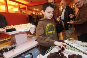 Picking out a brownie from the Salt Air table inside Azura Clothing is Ryan Gubitosi from New York. BY STEVEN BILLUPS