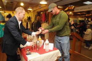 Brian Jennings, right, from Milford takes a sample of a Svedka chocolate martini from Svedka Sales Manager Scott Unruh inside Carlton’s. BY STEVEN BILLUPS