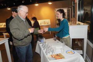 Lew Winans, left, of Rehoboth Beach finishes off his evening with a taste of 16 Mile beer inside Studio S Jewelry. Serving up the brew is Hobos volunteer Jane Matt. BY STEVEN BILLUPS