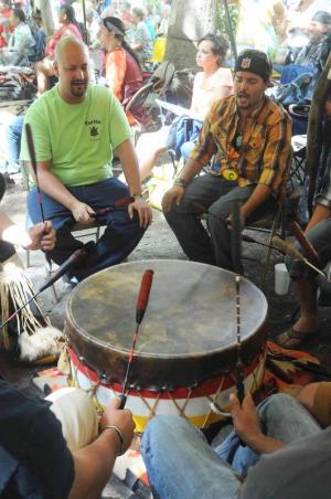 Josh Stewart, left, and Matt Martin of the Turtle Clan sing and drum during the powwow. There were three drum groups creating the music for the dances.