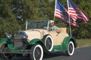 Herman Jackson's Model A follows the walkers, with Lawrence Casper and Del Jackson driving. BY DENY HOWETH