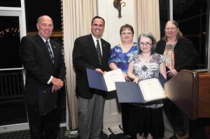 Displaying their tributes from the Delaware House of Representatives and Senate, the Smiths were honored for their swim team concession stand work and raising money for the swim team and Sussex YMCA. Shown are (l-r) Rep. Pete Schwarztkopf, D-Rehoboth; Sen. Ernie Lopez, R-Lewes; Stephanie Smith; Rebecca Smith; and Laurie Smith. BY STEVEN BILLUPS