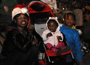 Keisha Harmon of Milton, left, enjoys the parade with daughters Keylonna, 14 months, and Keymiah, 7. BY DAN COOK