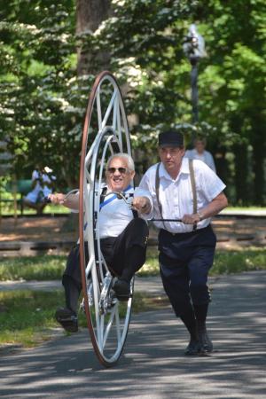 Ray Montsch of Dover, Wheelmen state captain, gets a push from Ed Lee as he rides a Monovelo bike built by Lee. It's a replica of the bikes used in the opening ceremonies of the 2008 Olympic Games in Beijing. BY RON MACARTHUR