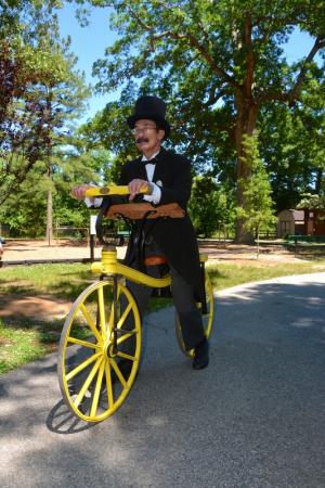Dave Gray of Doylestown, Pa., sits on a replica of what is thought to be the first two-wheeled bicycle built in England in 1819. The bike is a coaster bicycle without a chain. BY RON MACARTHUR