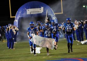 The Cavaliers take the field behind No. 56 Luke Elentrio. BY DAN COOK