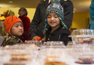 Andy and Franklin Hernandez choose their pies at the take out table during the community dinner. BY DENY HOWETH