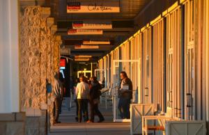 Rays from the Black Friday sunrise shine on people getting an early start on holiday shopping at Tanger Outlets in Rehoboth Beach. Tanger stores opened at 6 p.m. Thanksgiving and then at 6 a.m. on Black Friday. BY RON MACARTHUR