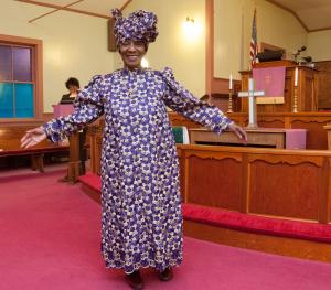 The Rev. Wassetta Moses from Bethel AME in Milford shows off an African Queen fashion. BY DENY HOWETH